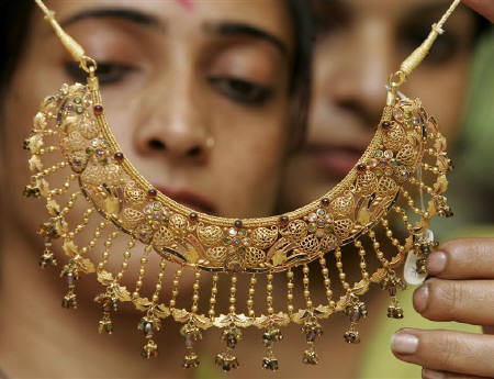 Women admire a gold necklace at a jewellery shop in Chandigarh October 18, 2007. India